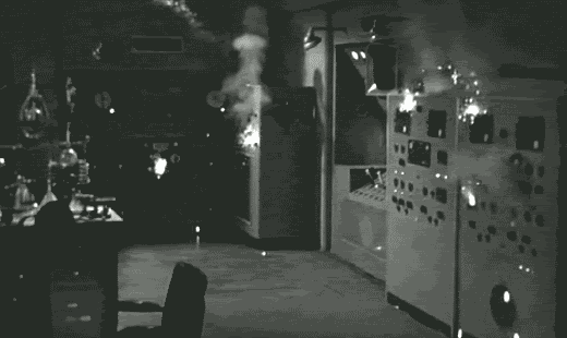 black and white laboratory machinery sparking and smoking