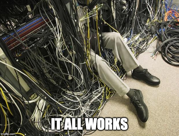 person's legs under complicated wiring with caption It All Works